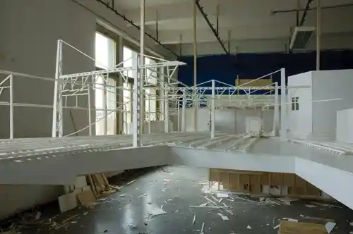 Installation model of a train station with suspended architectural elements in a workshop.