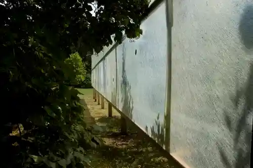 Side view of the translucent hunting blind surrounded by lush green vegetation.