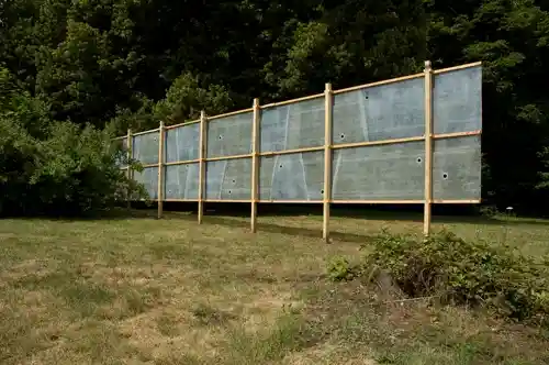 Wide view of the elongated translucent hunting blind blending with the natural landscape.